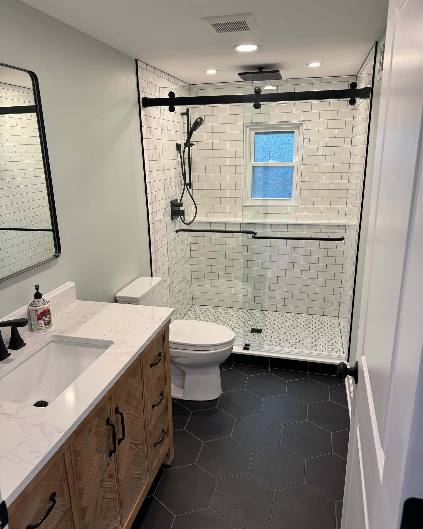 Bathroom remodel with dark hex tile