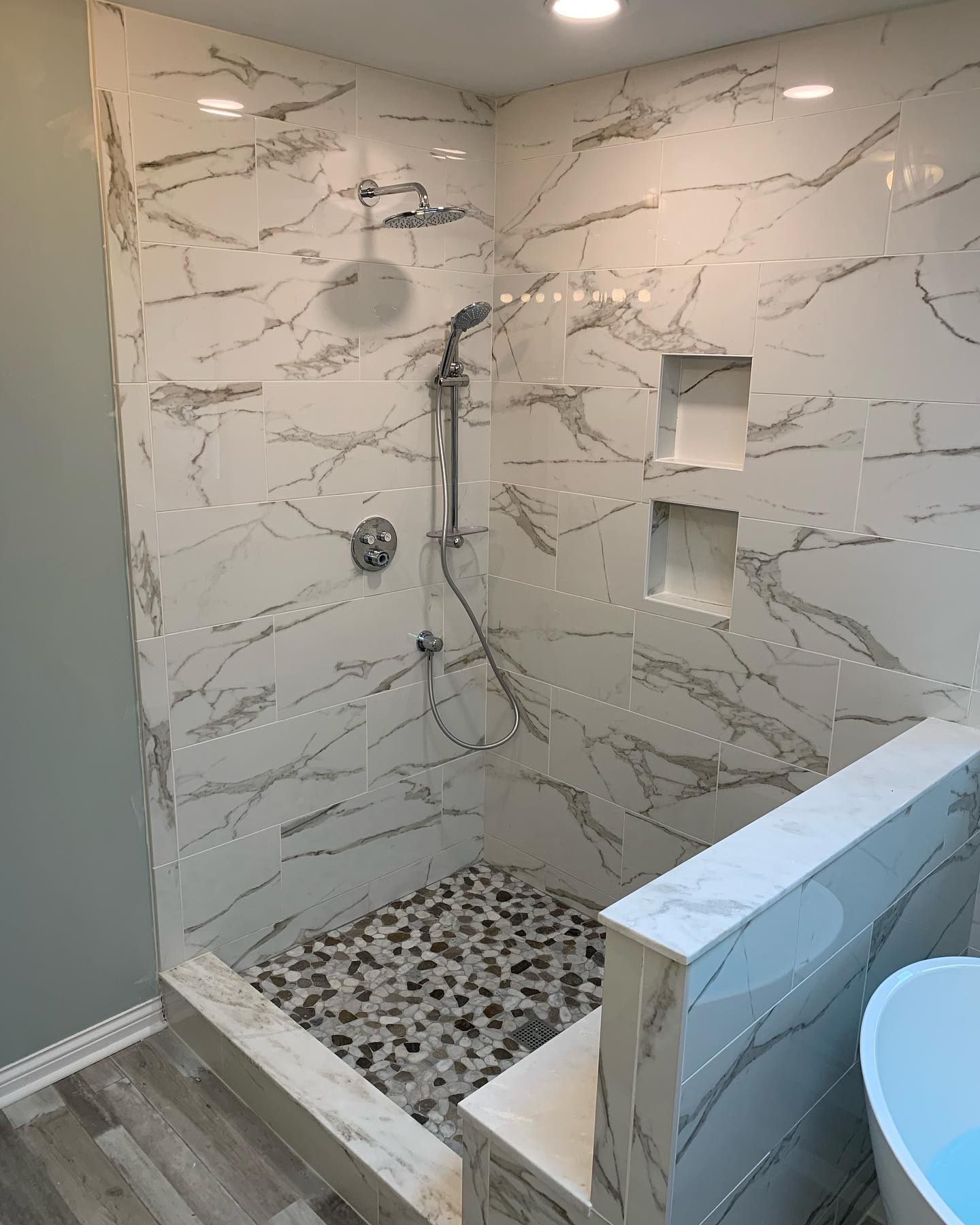 Custom pebble tile shower by ADR Construction