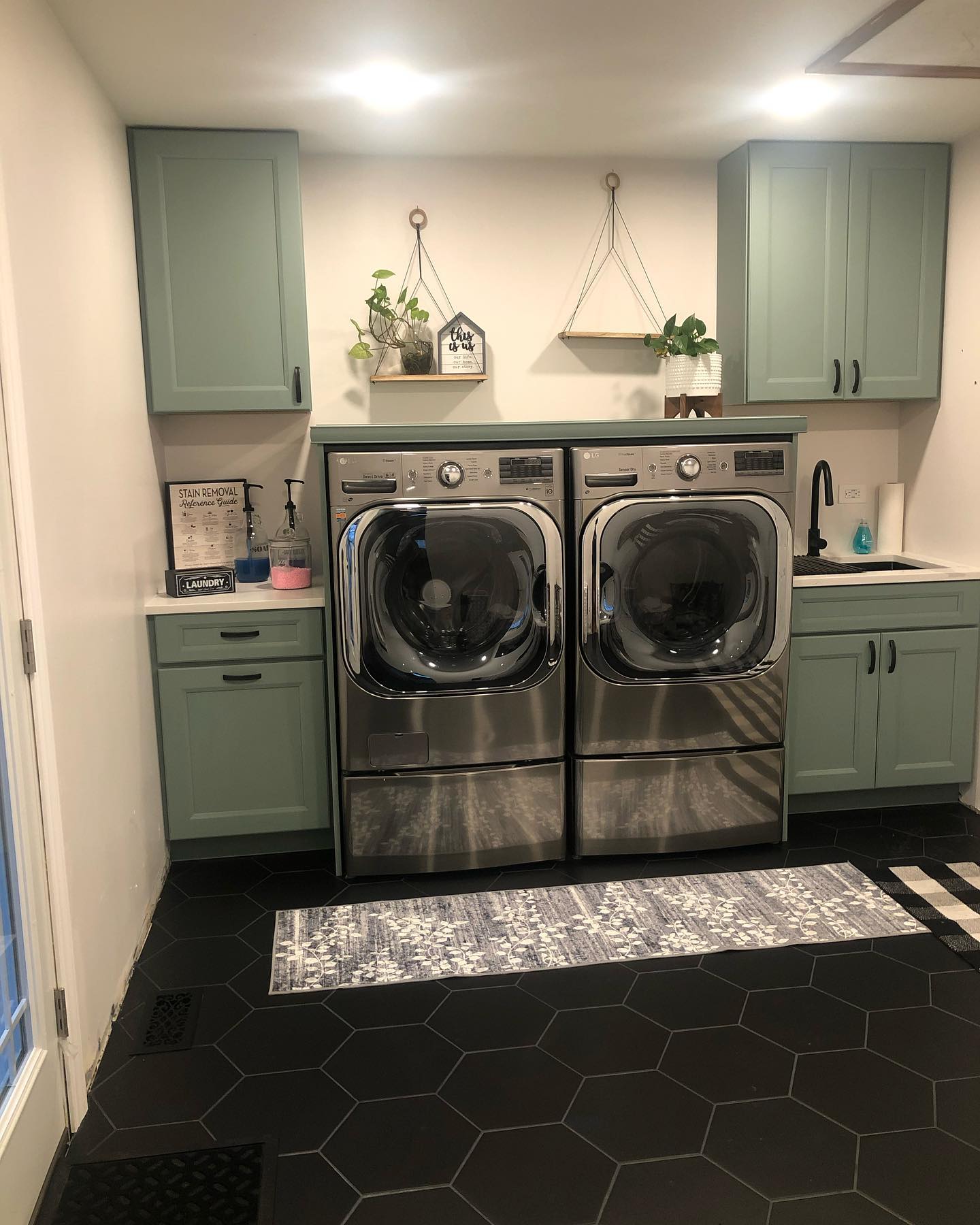 Laundry room remodel with sage green cabinets by ADR Construction