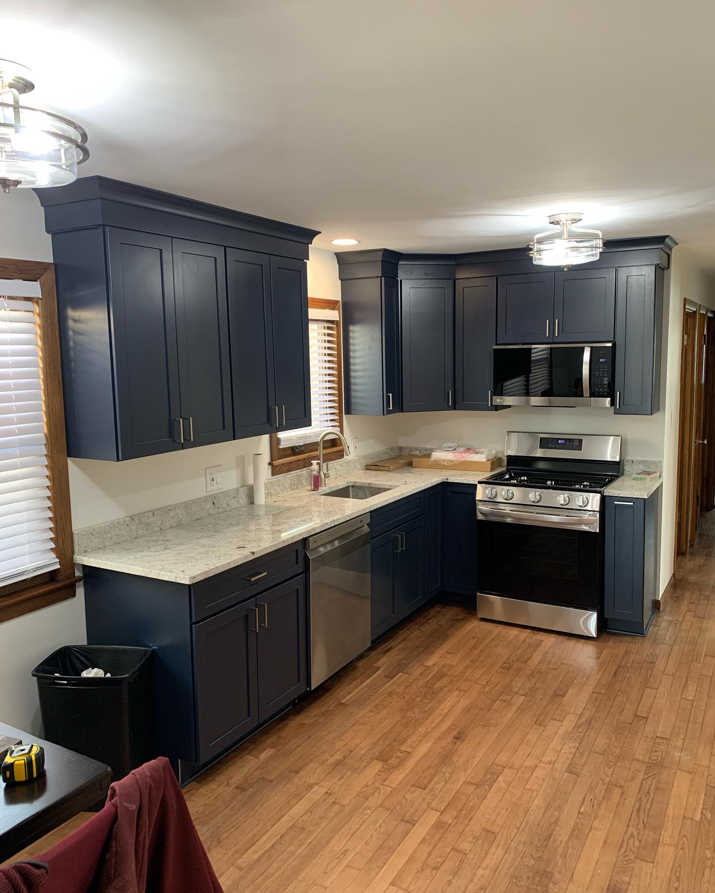Finished kitchen remodel with white cabinetry by ADR Construction