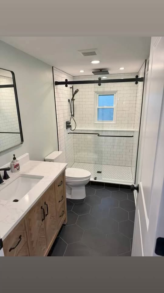 Full basement transformation with custom bathroom by ADR Construction