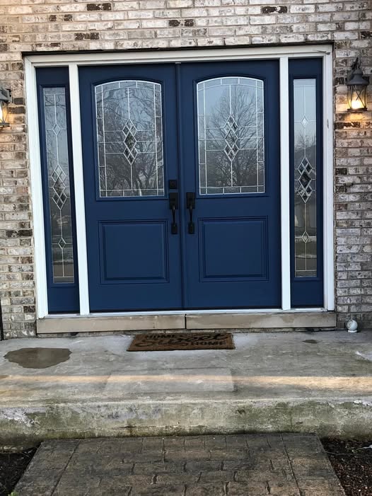 Blue double door entry with decorative glass by ADR Construction